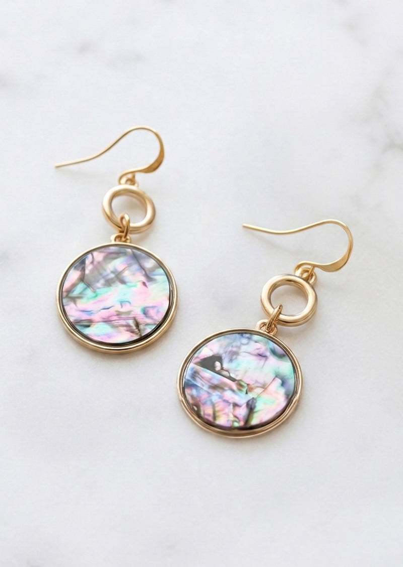 Gold earrings with multicolored round stones on a light background