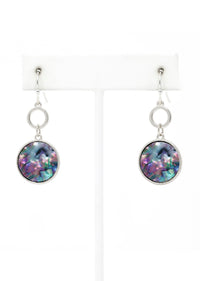 Multicolored round earrings on white stands