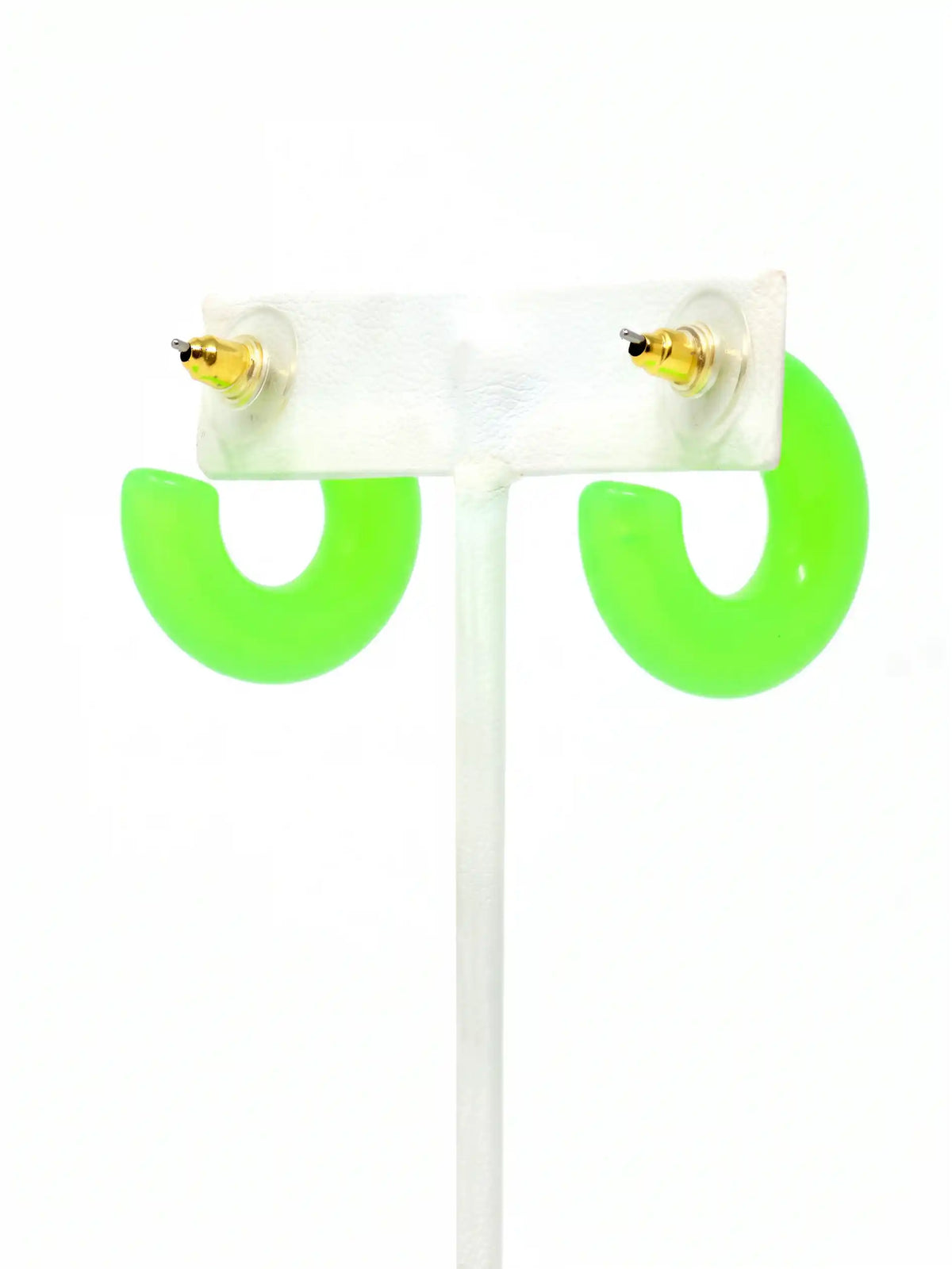 A pair of neon green colored resin hoop earrings with a bold rounded 25mm design.