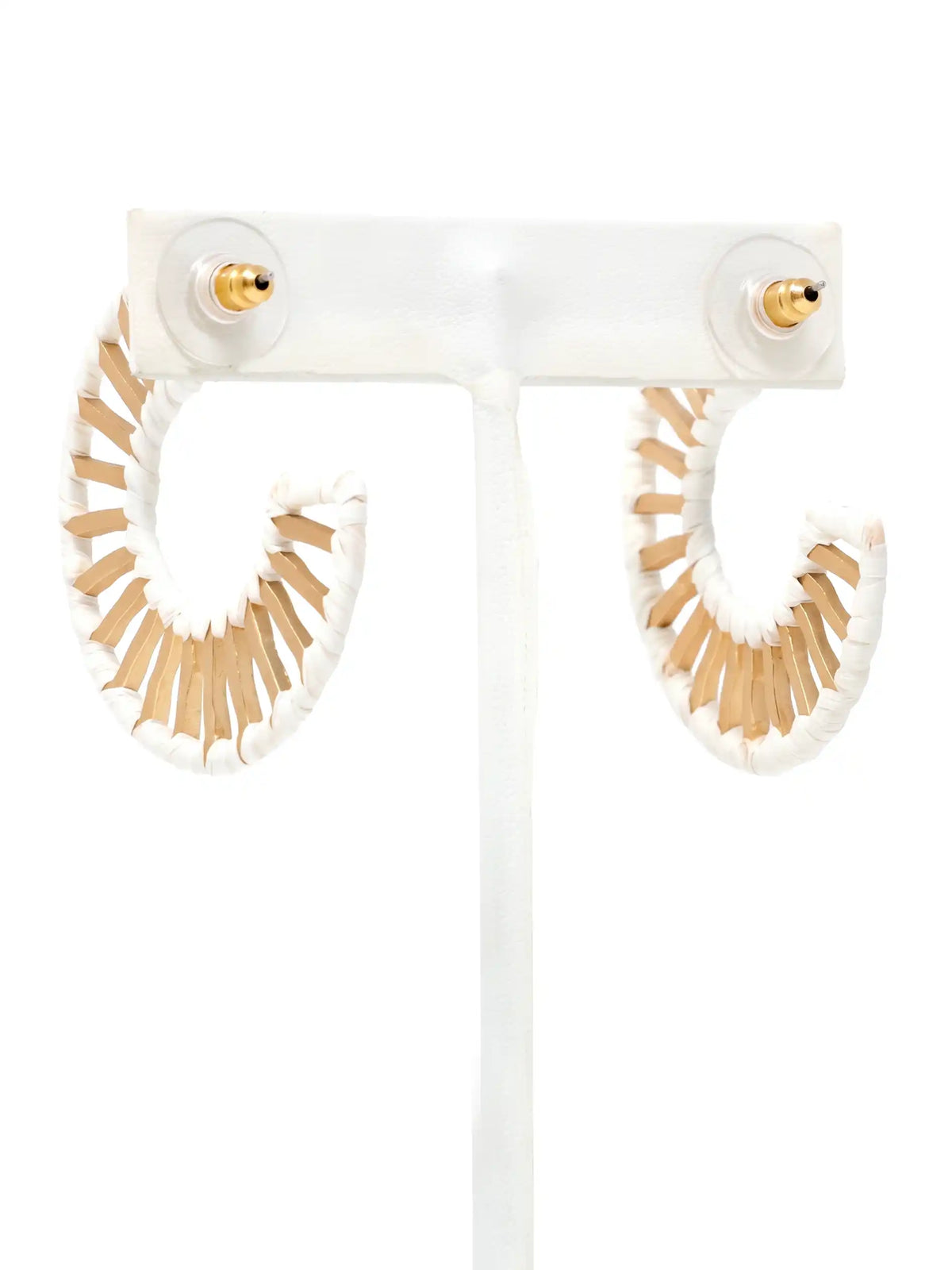 White and beige fringe hoop earrings displayed on a clear acrylic stand against a white background.