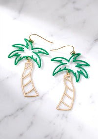A pair of cutout palm tree drop earrings featuring bright green palm leaves and a gold-tone trunk, dangling from gold hook backings.