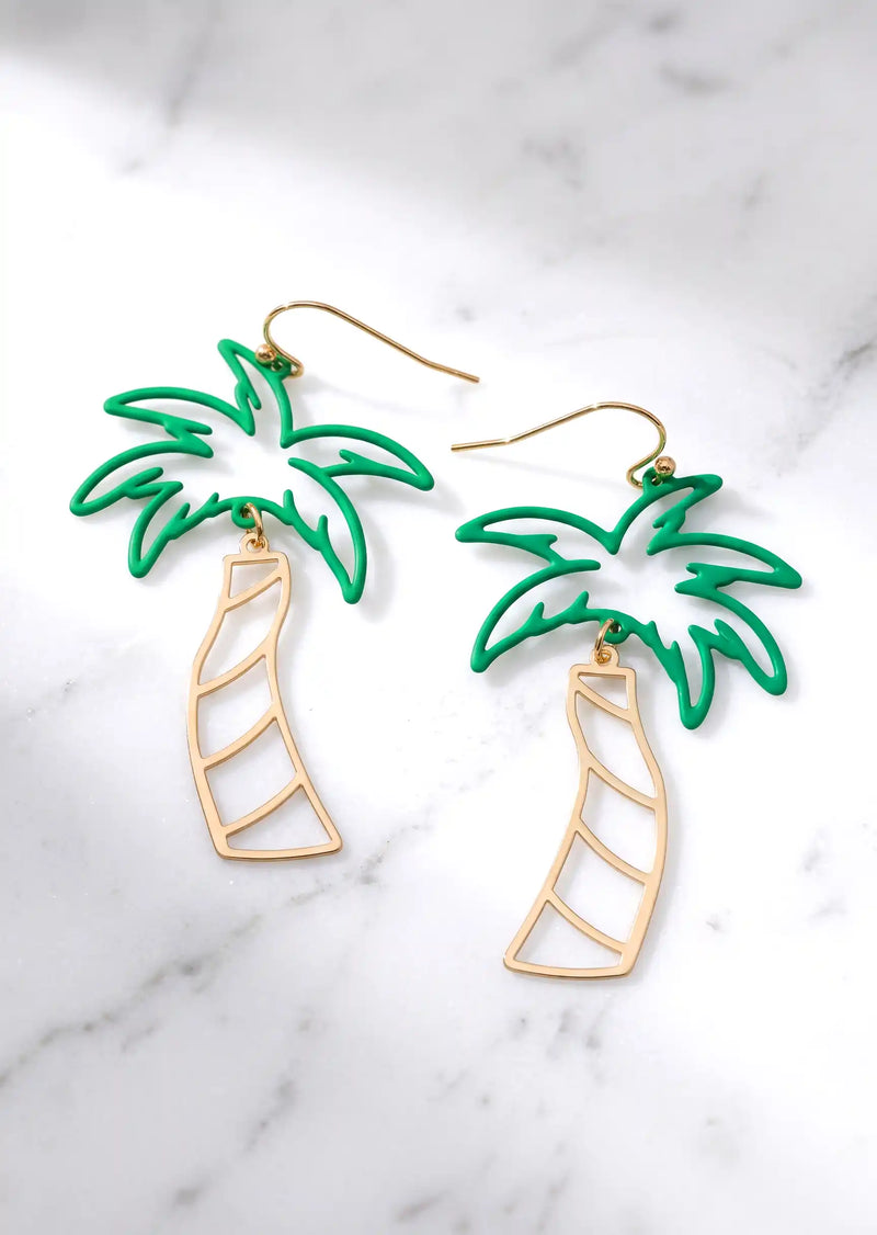 A pair of cutout palm tree drop earrings featuring bright green palm leaves and a gold-tone trunk, dangling from gold hook backings.