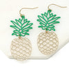A pair of chic pineapple earrings with dangling design, showcasing green epoxy-coated tops resembling tropical leaves.