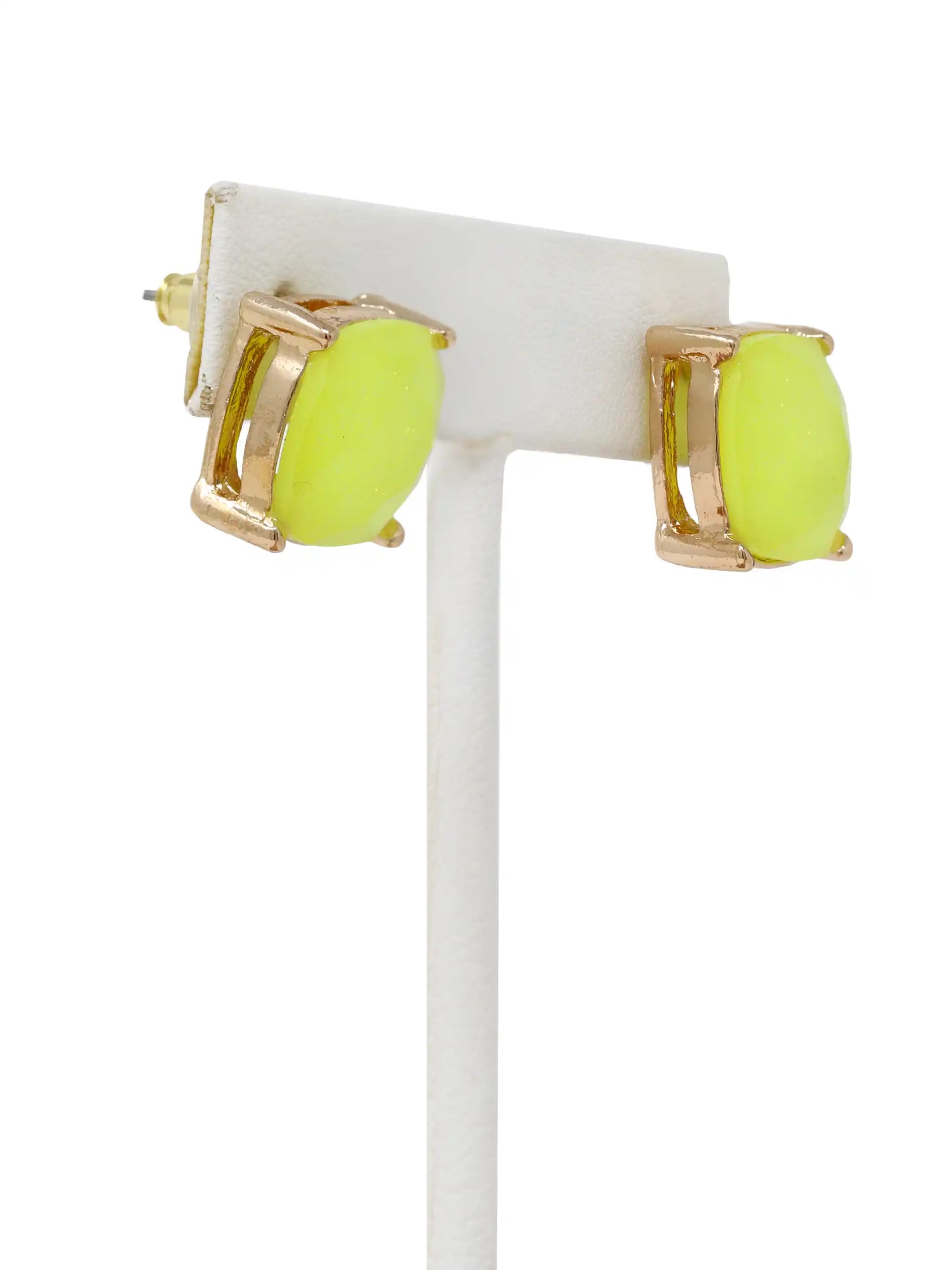 Neon green earrings with gold accents on a white stand