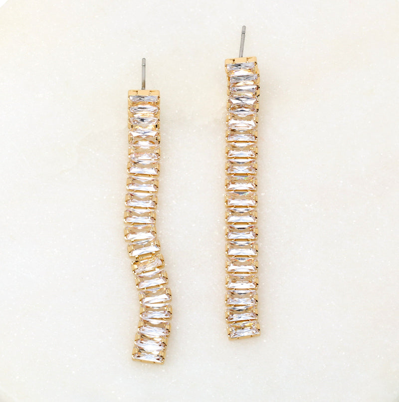 A pair of baguette crystal stone fringe earrings in gold.