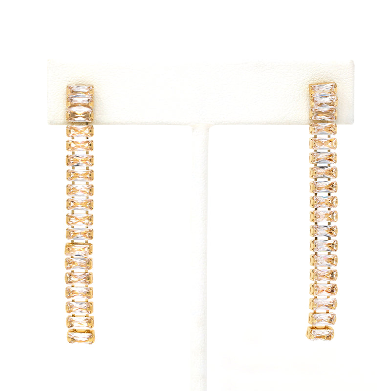A pair of baguette crystal stone fringe earrings in gold.