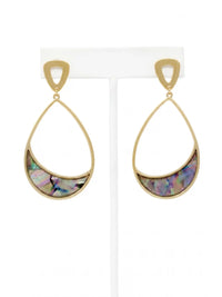 A pair of gold teardrop dangle earrings with a crescent-shaped iridescent abalone shell inlay, displayed on a white jewelry stand against a white background.