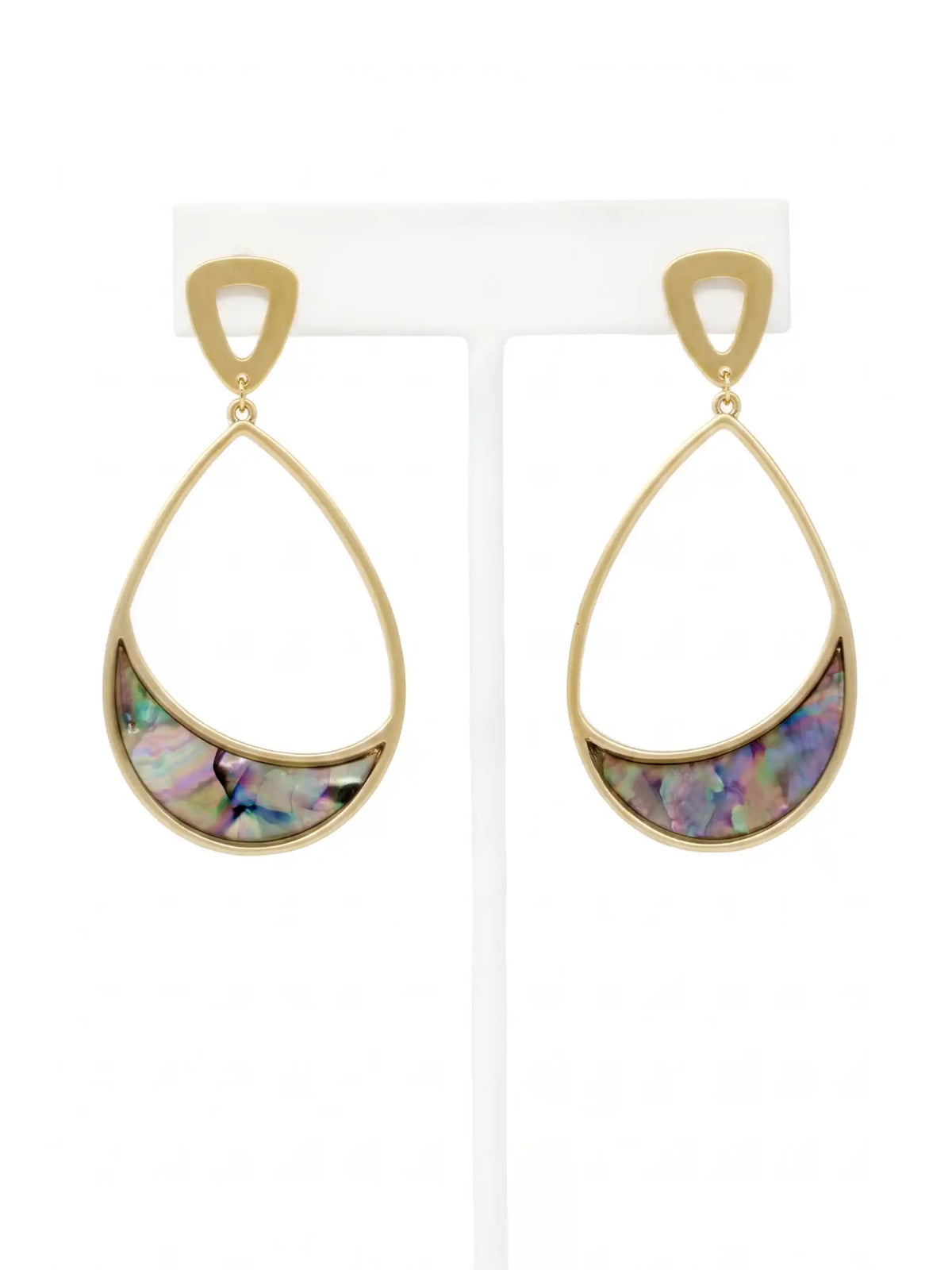 A pair of gold teardrop dangle earrings with a crescent-shaped iridescent abalone shell inlay, displayed on a white jewelry stand against a white background.
