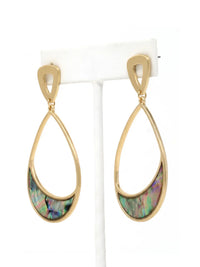 A pair of gold teardrop dangle earrings with a curved iridescent abalone shell inlay, displayed on a white jewelry stand against a white background.