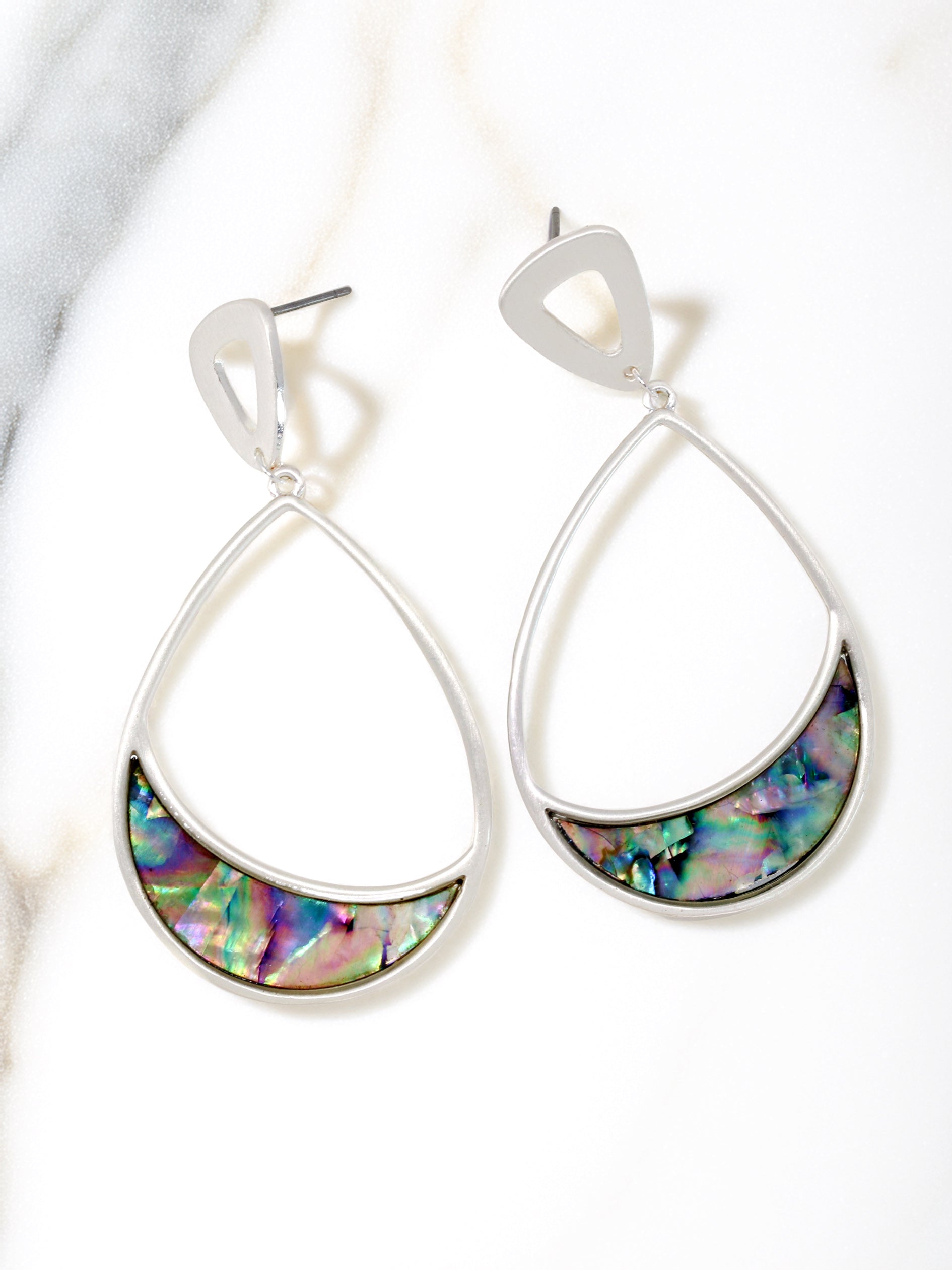 Teardrop-shaped earrings with colorful interior on a white background