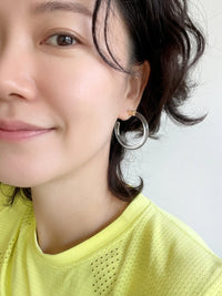 Pair of clear Lucite hoop earrings by Bauble Sky featuring polished transparent resin, gold-tone accents, and a modern minimalist design.