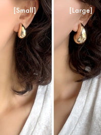 Side-by-side comparison of a gold teardrop-shaped hoop earring worn on a model's ear, labeled [Small] on the left and [Large] on the right.