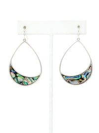 A pair of silver teardrop dangle earrings with crescent-shaped abalone shell inlays, displayed on a white jewelry stand against a white background.