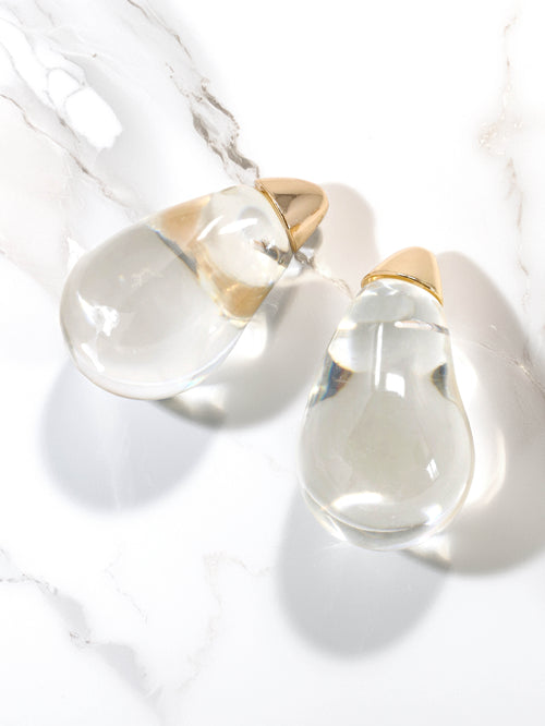 Clear lucite puffy teardrop earrings feature sleek and polished transparent resin teardrops that catch the light beautifully. 

