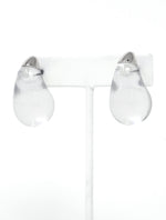 A pair of clear resin teardrop-shaped stud earrings with silver-toned caps, showcasing their smooth, glossy finish and minimalist design.
