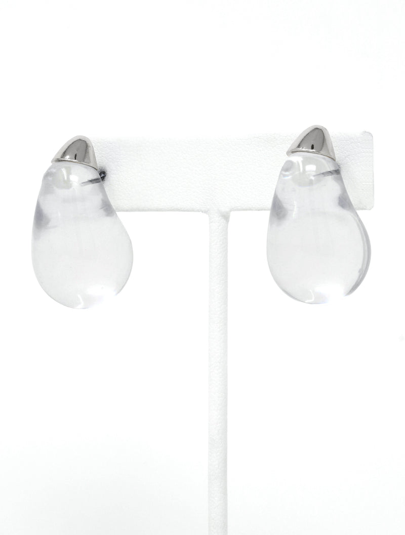 A pair of clear resin teardrop-shaped stud earrings with silver-toned caps, showcasing their smooth, glossy finish and minimalist design.