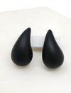 A close-up of black puffy hollow teardrop earrings, showcasing their modern and minimalist design. The earrings make a statement with their sleek metal construction and distinctive shape.
