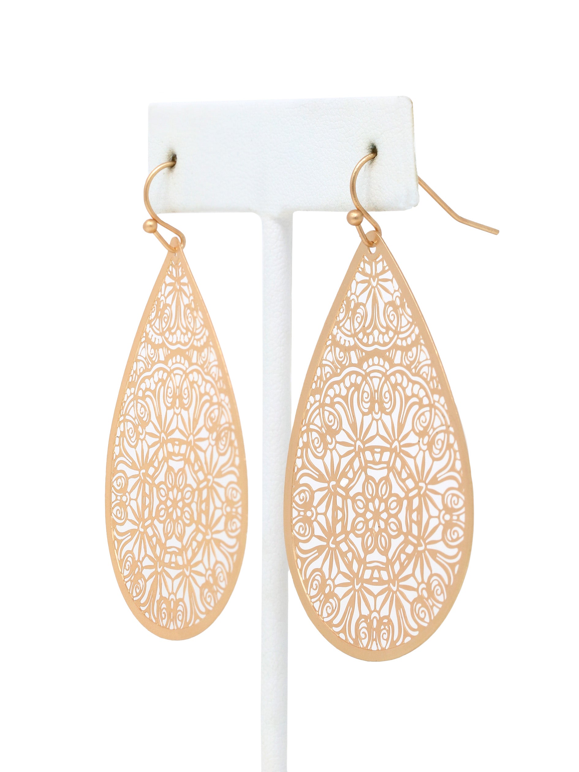 Gold teardrop earrings with intricate patterns on a white background.