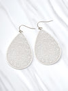 Teardrop-shaped earrings with floral patterns on a white background