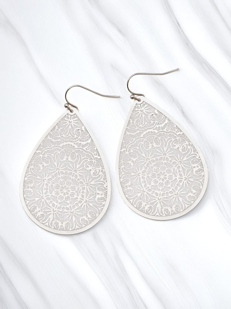 Teardrop-shaped earrings with floral patterns on a white background