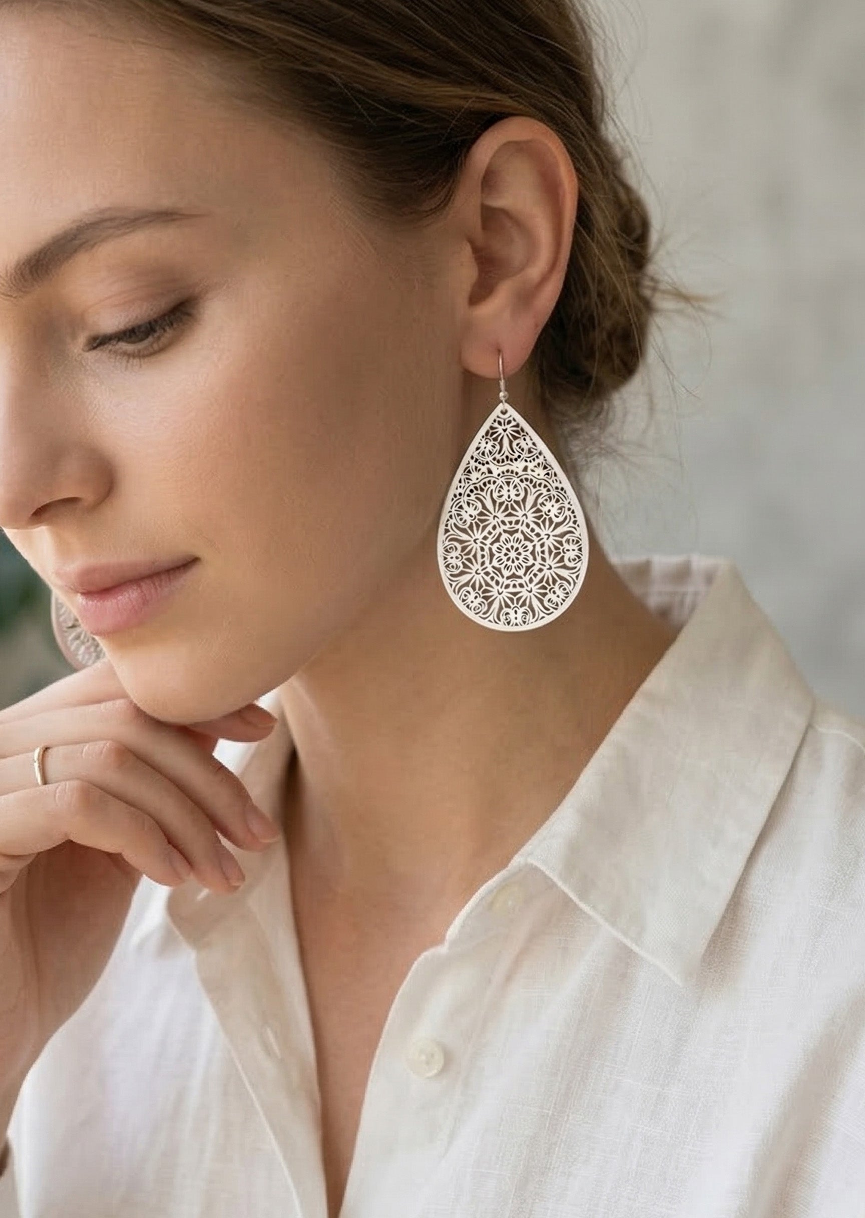 Woman wearing a decorative earring with a blurred background