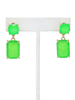 Neon green rectangle-shaped glass stone drop earrings with faceted detailing, set in gold-tone metal.