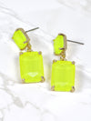 Neon yellow rectangle-shaped glass stone drop earrings with faceted detailing, set in gold-tone metal, displayed on a white earring stand.
