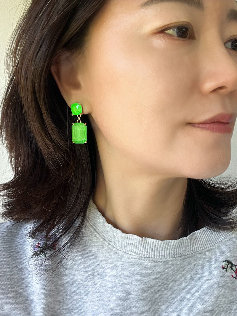 Neon green rectangle-shaped glass stone drop earrings with faceted detailing, set in gold-tone metal.