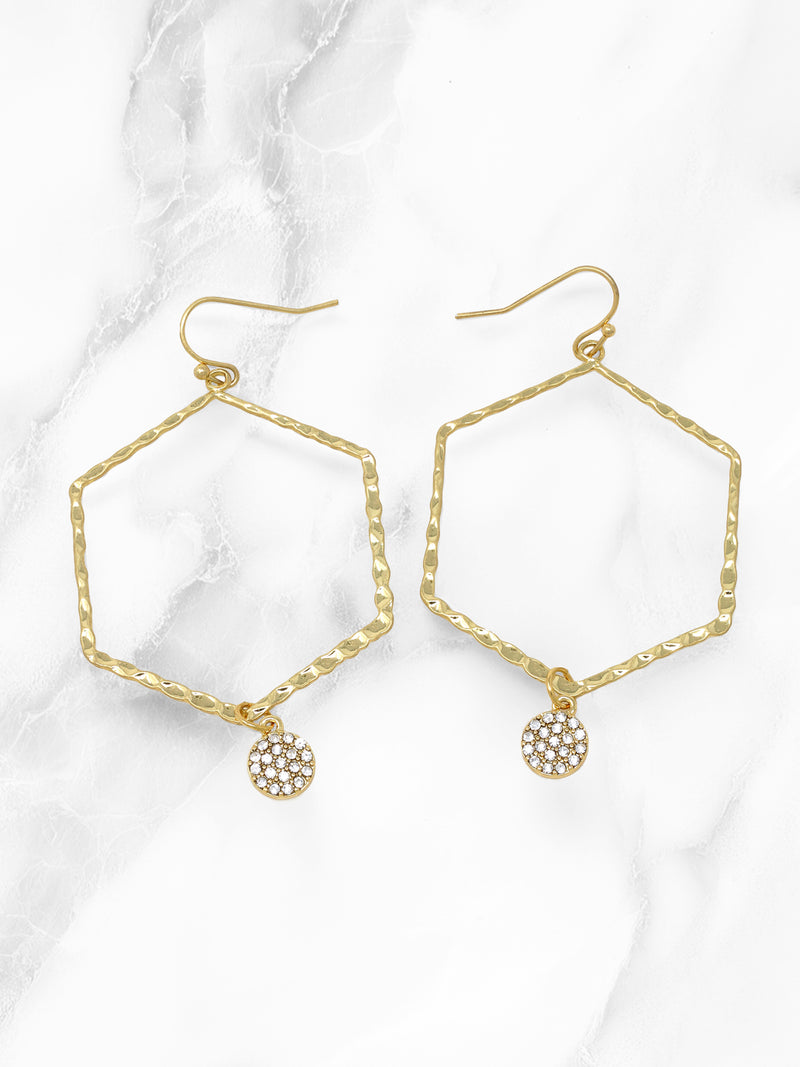 A pair of gold-tone hammered hexagon drop earrings with a small round paved charm. The earrings feature a geometric open-frame design with a dangling crystal-accented charm for a modern and elegant look.