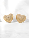 A pair of gold-tone textured puffy heart stud earrings with a delicate, intricate surface pattern.