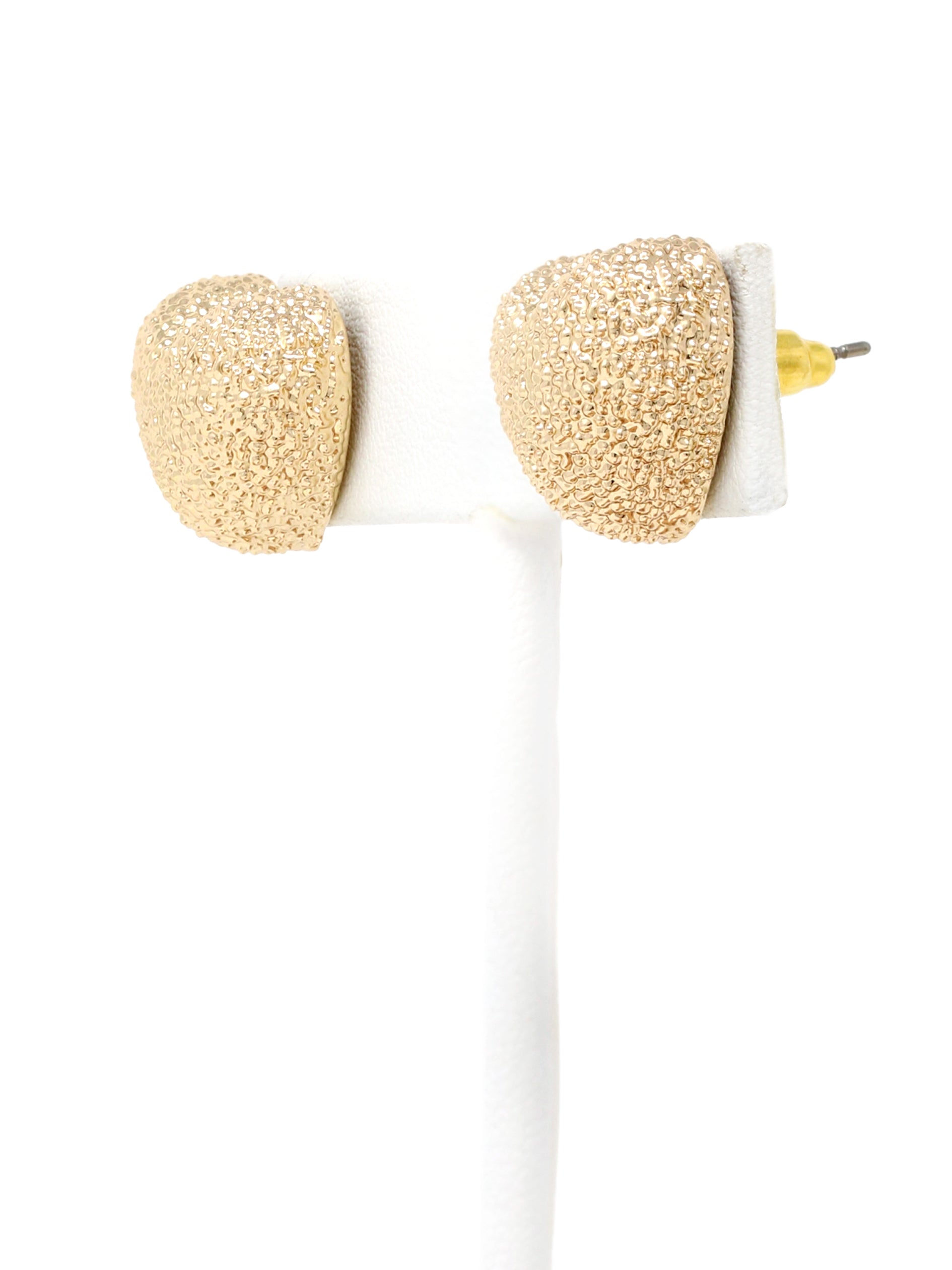 A pair of gold-tone textured puffy heart stud earrings with a delicate, intricate surface pattern.