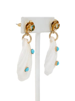 A pair of white natural shell drop earrings featuring turquoise accent stones and gold floral studs.