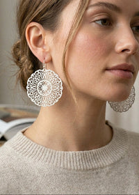 Lightweight round filigree metal drop and dangle earrings featuring an intricate openwork circular design in a silver-tone finish.