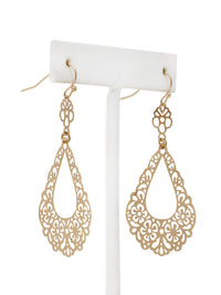 Gold filigree earrings on a white stand