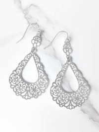 Silver filigree earrings on a white background