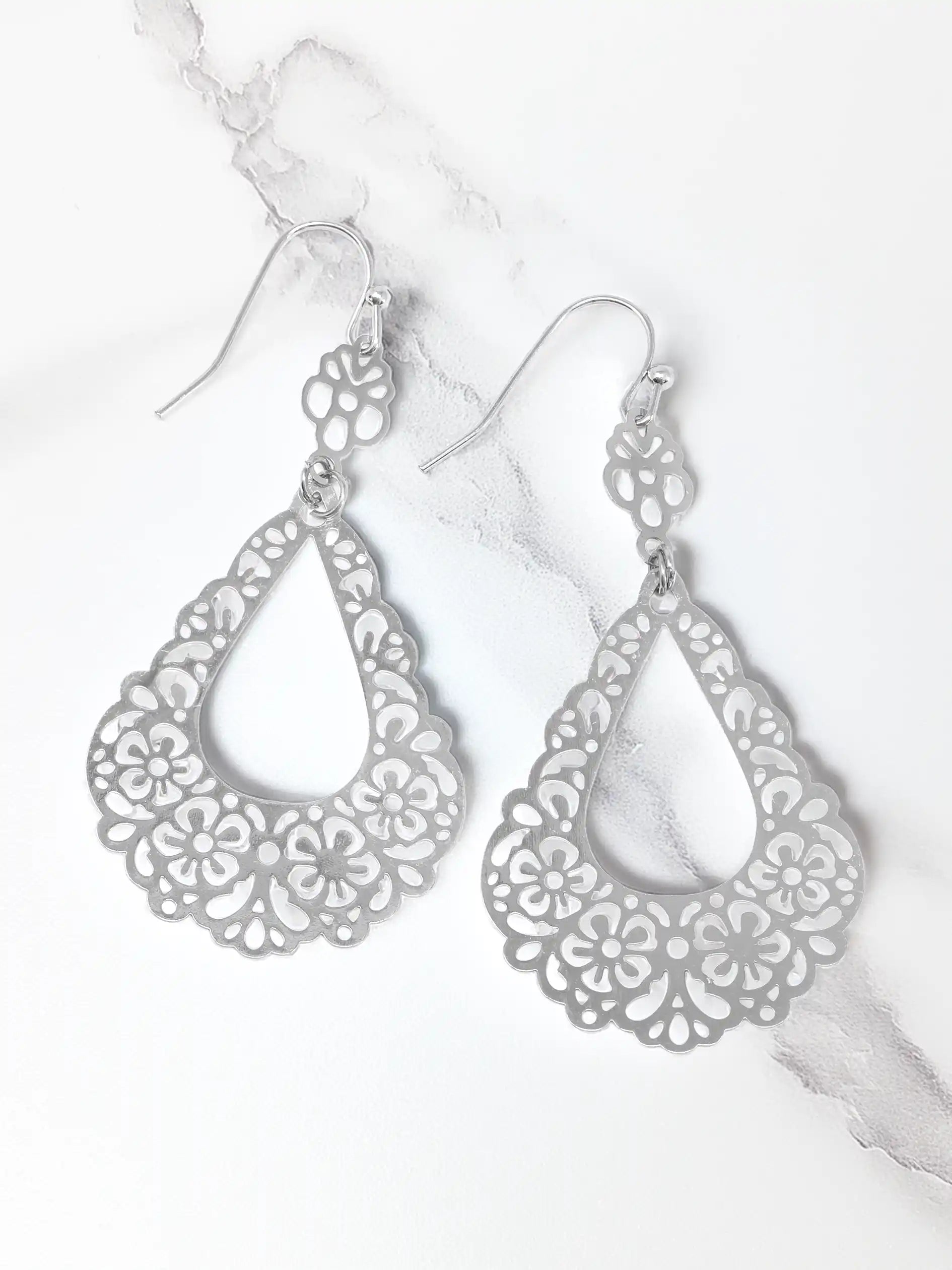 Silver filigree earrings on a white background