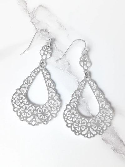 Silver filigree earrings on a white background