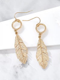 Gold leaf drop dangle earrings with textured circular links and detailed cutout leaf pendants.