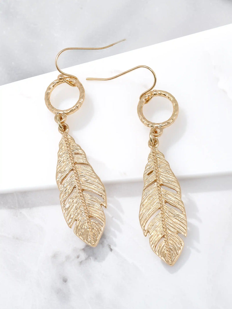 Gold leaf drop dangle earrings with textured circular links and detailed cutout leaf pendants.