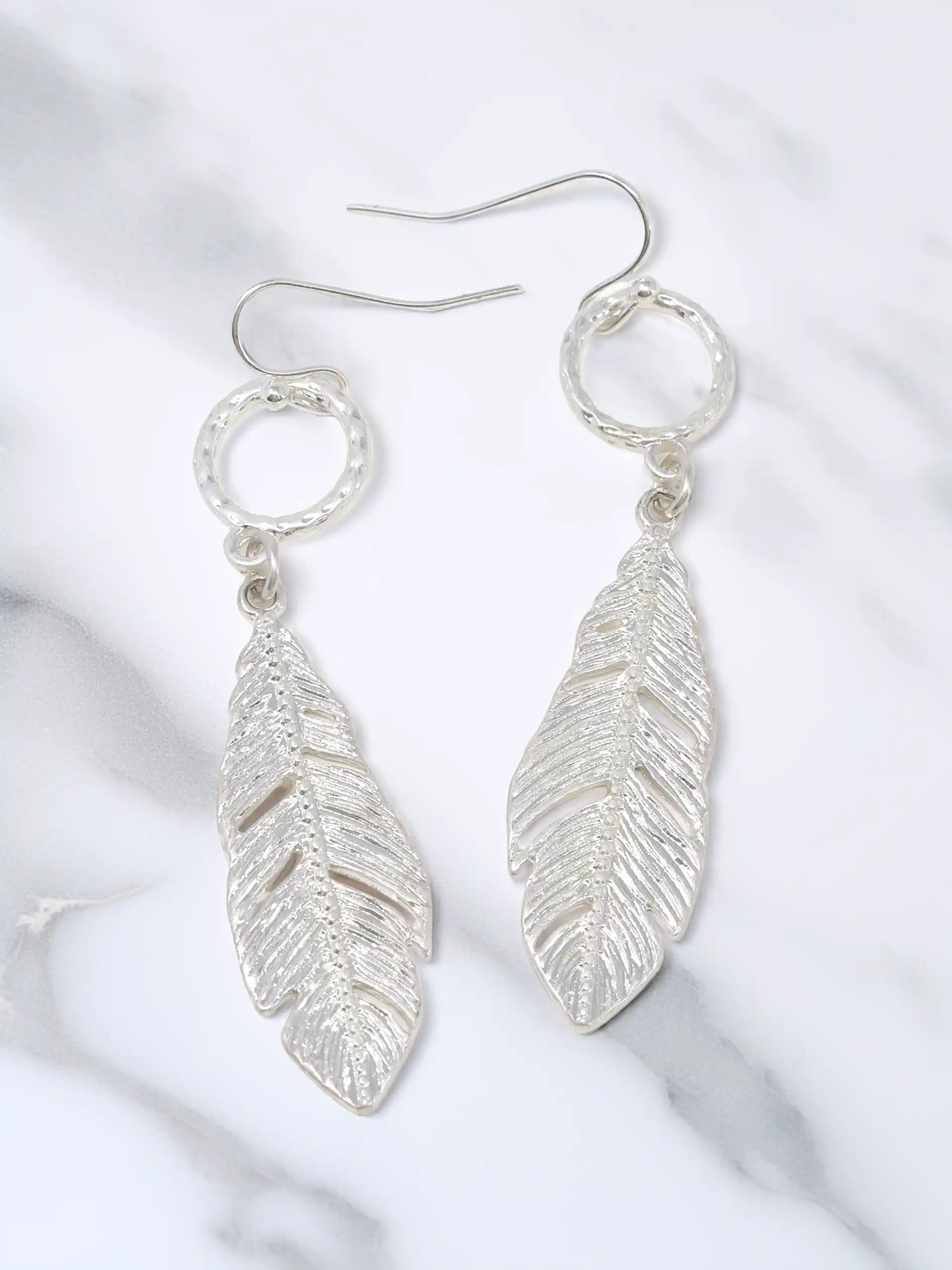 Silver leaf drop dangle earrings with textured circular links and detailed cutout leaf pendants.