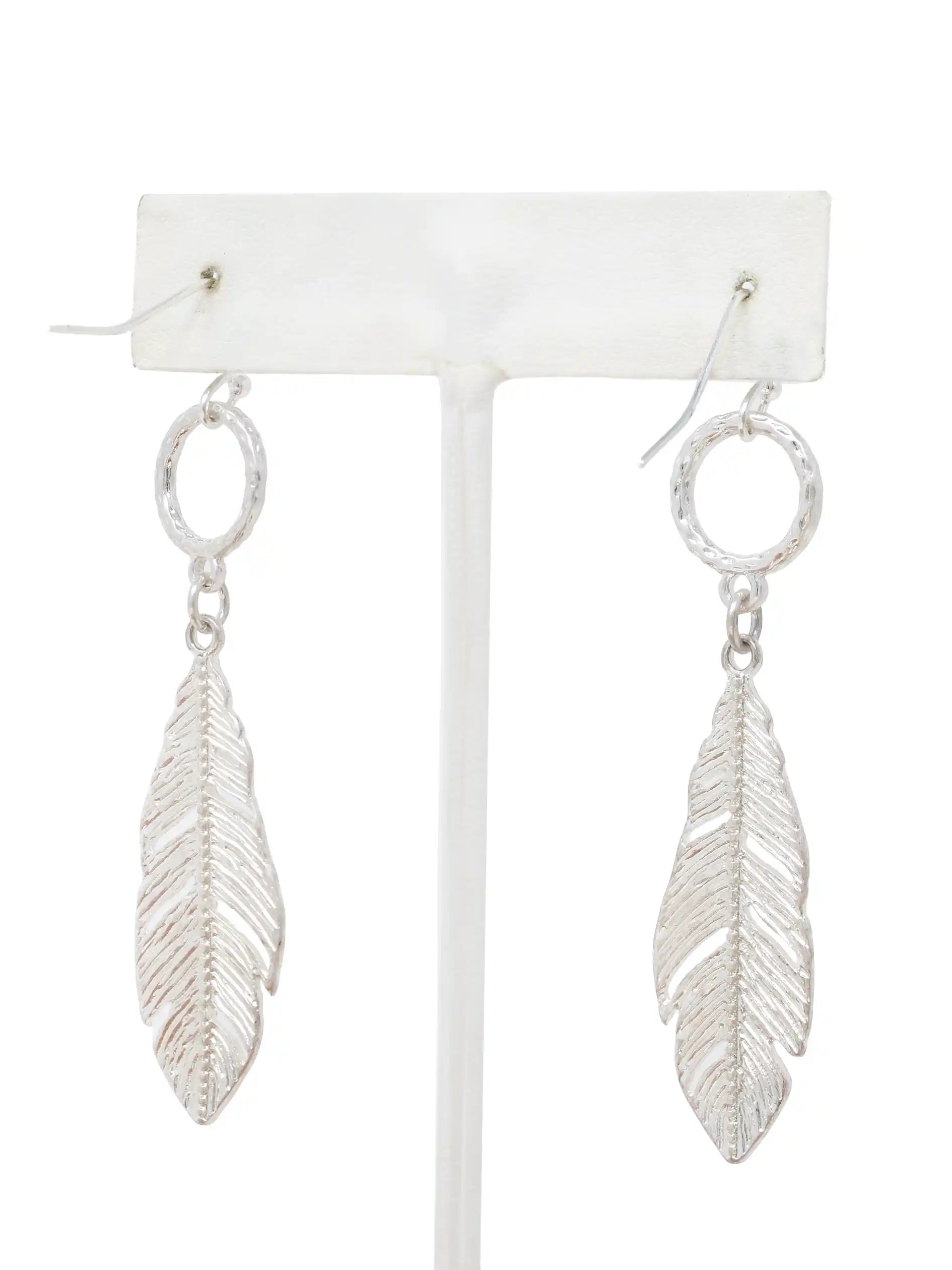 Silver leaf drop dangle earrings with textured circular links and detailed cutout leaf pendants.