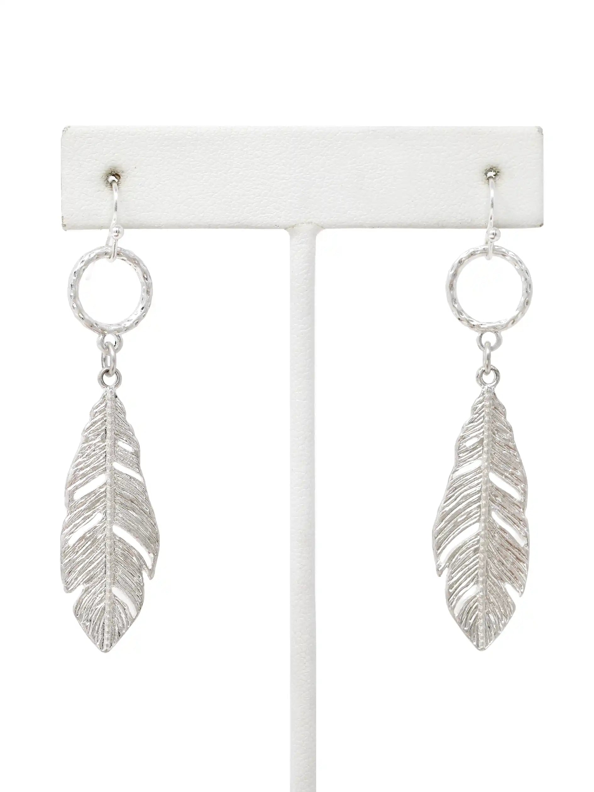 Silver leaf drop dangle earrings with textured circular links and detailed cutout leaf pendants.