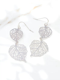 Silver leaf-shaped earrings on a white background
