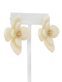 Pair of cream-colored floral earrings on a white background