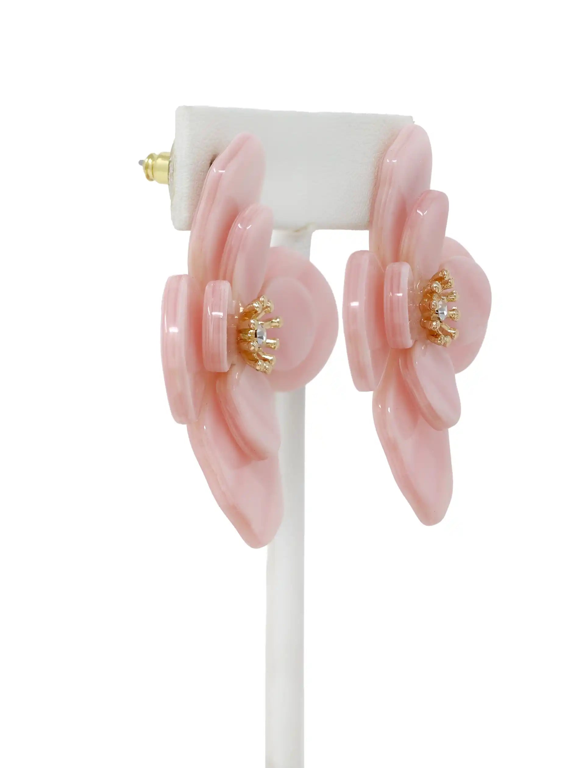 Pink floral earrings with gold centers on a white background