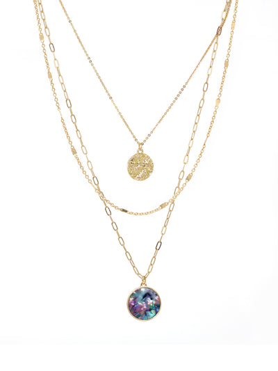 Triple-layered gold necklace featuring a dangling charm made of natural abalone.