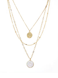 Triple-layered gold necklace featuring a dangling charm made of natural Mother of Pearl.
