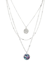 Layered silver necklaces with colorful abalone pendant on a white background.