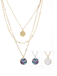 Triple-layered gold necklace featuring a dangling charm made of natural Mother of Pearl or abalone.