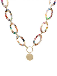 A statement necklace against a white background, featuring large, oval multi colored resin links connected by gold-toned metal and a central, polished gold-toned circular pendant.
